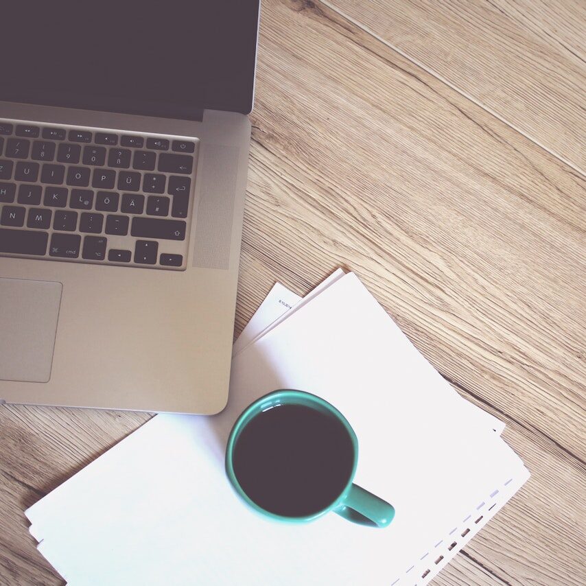 Betsy Lugo Creative Labtop and coffee on a desk